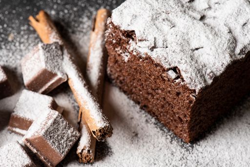 A closeup of a chocolate pastry covered in powder sugar