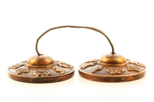 The tibetan buddhist tingsha cymbals isolated on white background
