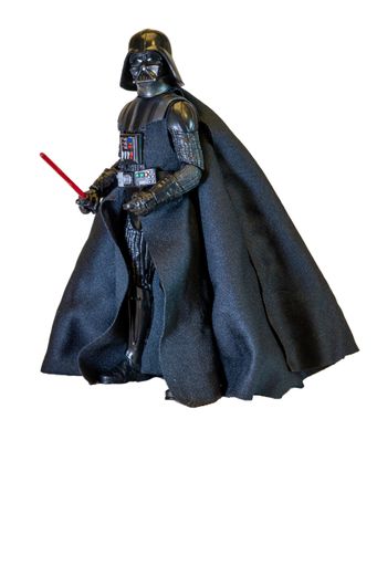 Portrait of Darth Vader replica and his red sword. Lord Vader is a fictional character of Star Wars saga.