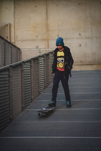 A closeup of a young teenager skating on Beaugrenelle area in Paris