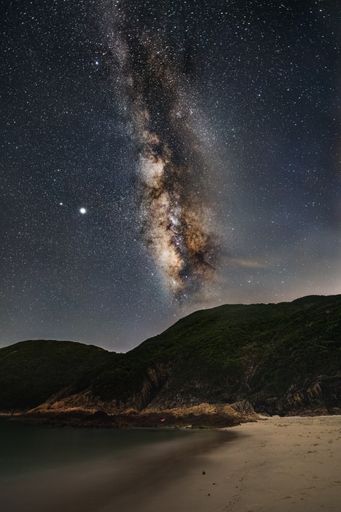 A beautiful scenery of Milky Way Galaxy in the night sky over a landscape in Hong Kong