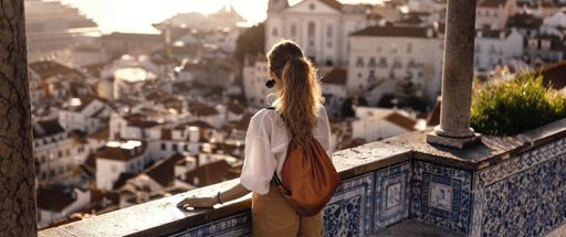 A landscape shot of a young female traveler enjoying the beauty of Portuguese and Spanish cities
