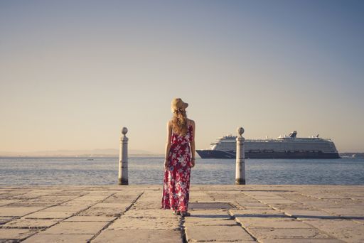 A landscape shot of a young female traveler enjoying the view in Cais das Colunas Lisbon Portugal