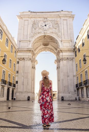 A vertical shot of a young female traveler enjoying the view  Praça do Comércio Lisbon Portugal