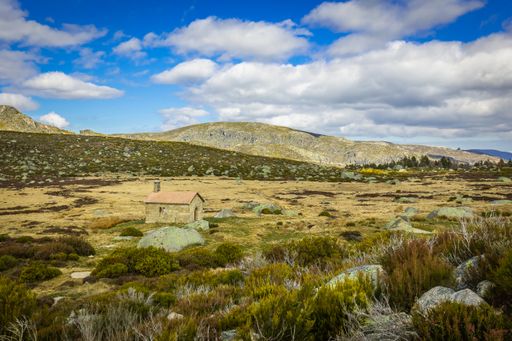 A beautiful shot of a rural mountain area under a blue cloudy sky in Serra da Estrela, Portugal