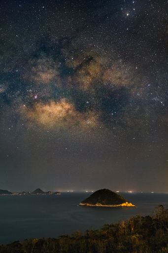 A beautiful scenery of Milky Way Galaxy in the night sky over a landscape in Hong Kong