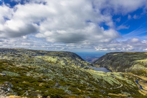 A beautiful shot of a rural mountain area under a blue cloudy sky in Serra da Estrela, Portugal