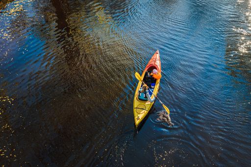 A woman canoeing on the water during daytime