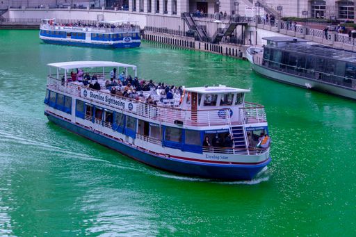 A closeup shot of a white boat sailing on the Chicago River