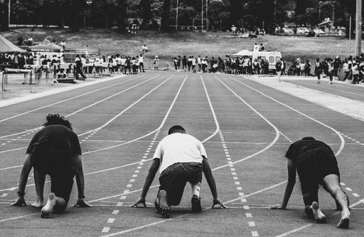 The grayscale shot of a bear runners about to run a marathon
