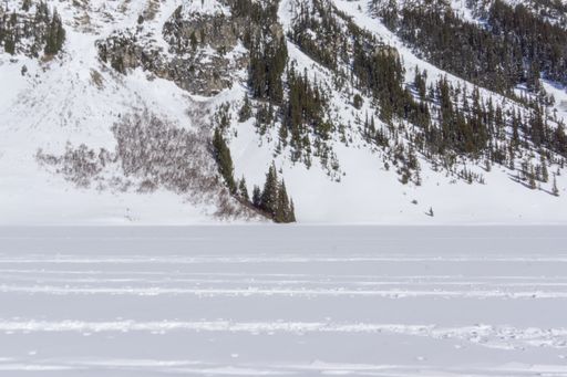 A snowy mountain and valley landscape scene during a cold winter day