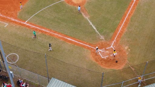 An aerial shot of a baseball field with a game in progress and people who have come to see it