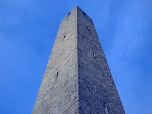 A low angle shot of a tower block under the beautiful blue sky