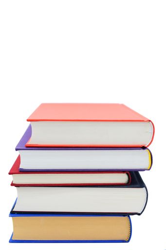A closeup shot of five books stacked over one another on a white background