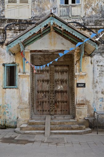 Ancient doors topped with a weathered roof, Zanzibar, Tanzania, Africa