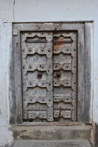 A vertical shot of Indian-style wooden doors in Zanzibar, Tanzania, Africa