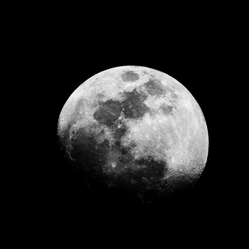 A beautiful closeup greyscale shot of the full moon in the night sky