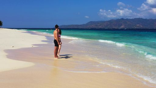 A beautiful caucasian couple enjoying time on the beach in Lombok, Indonesia