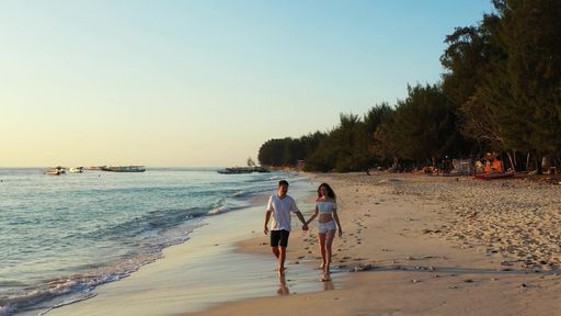 A romantic couple enjoying their time together on the beach on Gili Islands, Indonesia