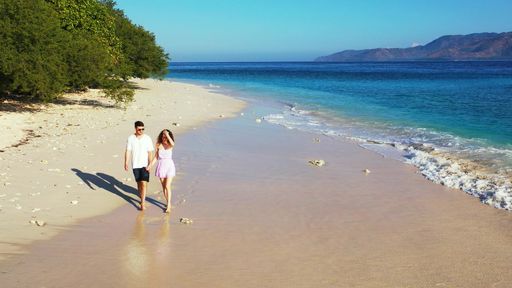 A romantic couple enjoying their time together on the beach on Gili Islands, Indonesia