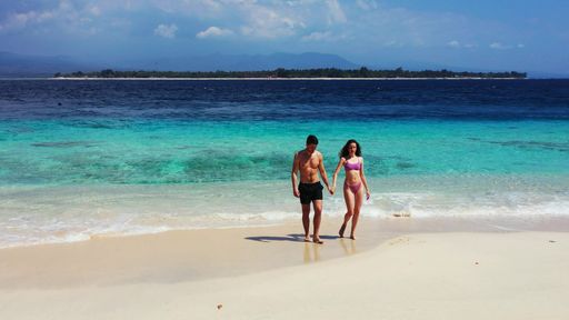 A romantic couple enjoying their time together on the beach on Gili Islands, Indonesia