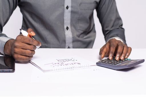 A closeup shot of a black businessman hands drawing on a page the lines of result and time, Strategy Concept