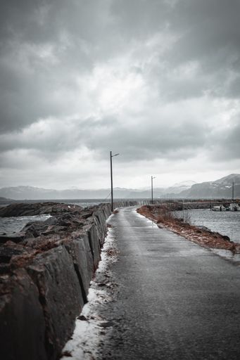 The vertical shot of a road path between a river