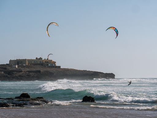 A beautiful shot of some paragliders in the Atlantic Ocean in Portugal during the day