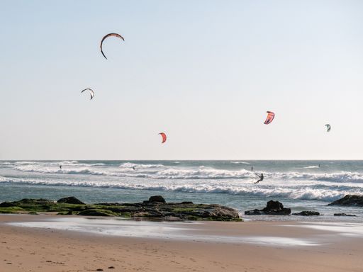 A beautiful shot of some paragliders in the Atlantic Ocean in Portugal during the day