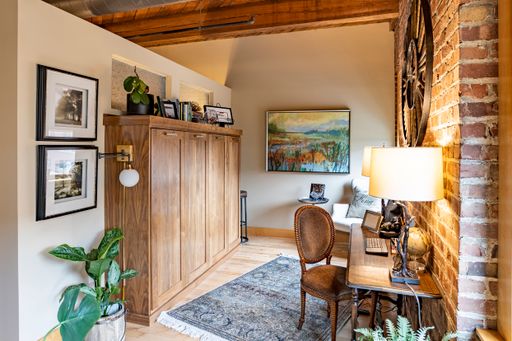 A beautiful office room interior with a rustic wooden design and vintage items