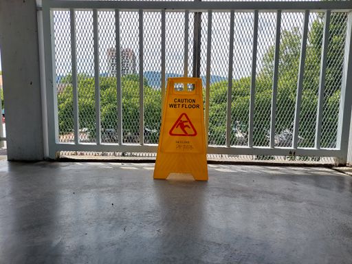 A "Caution. Wet Floor" sign on a balcony