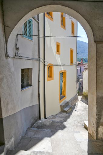 A vertical shot of a round arch in the historic center of Rivello, Italy in the Basilicata region