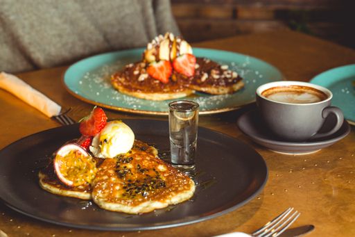 A beautiful shot of a tasty chocolate pancake with vanilla ice cream, nuts and berries