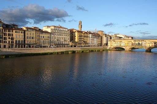 The unique architecture of Ponte Vecchio with the calm Arno river, Florence