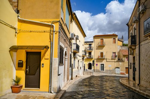 A photo of a narrow street and classic buildings in Lavello, an old town in Basilicata region, Italy