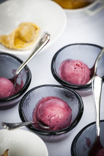 A selective focus shot of raspberry sorbet in small bowls on a white table