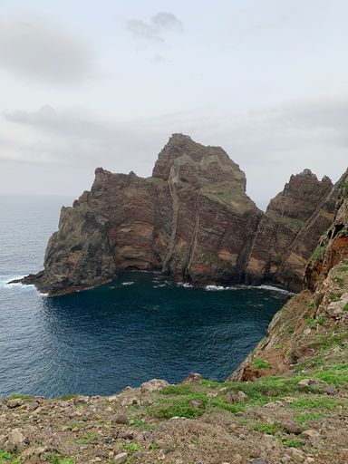 An Aerial shot of Point of Saint Lawrence (Ponta de Sao Lourenco) cliff under a gray cloudy sky