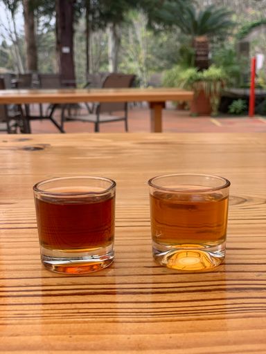 A closeup of two glasses of whisky or another drink on a cafe table in Madeira Island, Portugal