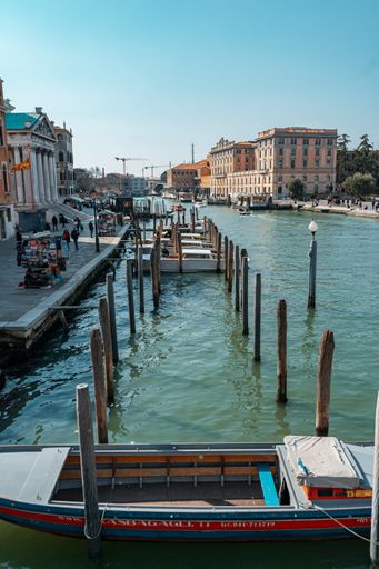 A picturesque river view in Venice, Italy, in warm sunlight and boats in the water
