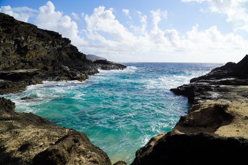 A beautiful shot of a bay surrounded by rocks in the daytime.