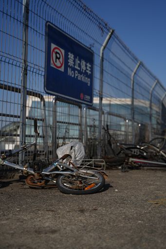 A vertical shot of abandoned bikes at a parking lot
