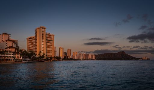 A panoramic shot of Waikiki neighborhood and Diamond Head volcano in the evening