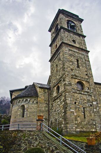 A low angle vertical shot of a bell tower with a cloudy sky in the background