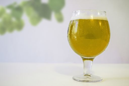 A closeup shot of a glass of fresh cold beer on the table