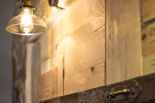 A selective focus shot of a light bulb on a wooden surface