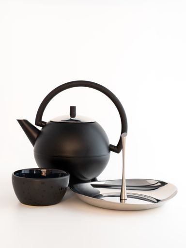 A vertical shot of a set with teapot, bowl and plate on the white background