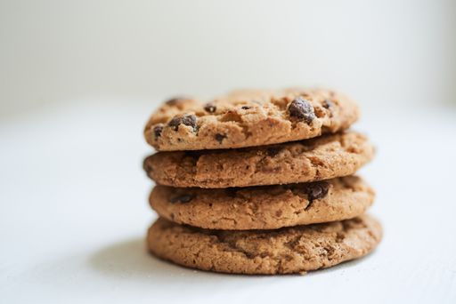 A selective focus shot of chocolate chip cookies on a white surface