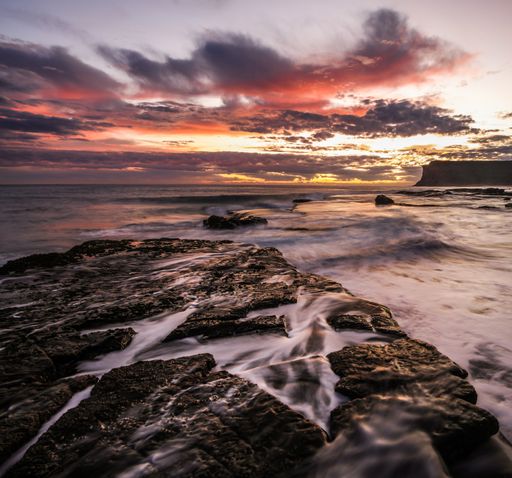 A beautiful shot of the sunset with colorful clouds above the sea