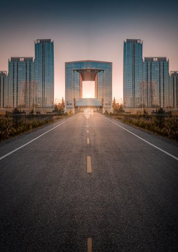 A vertical closeup of a long road leading to the Telecom center during sunset in China