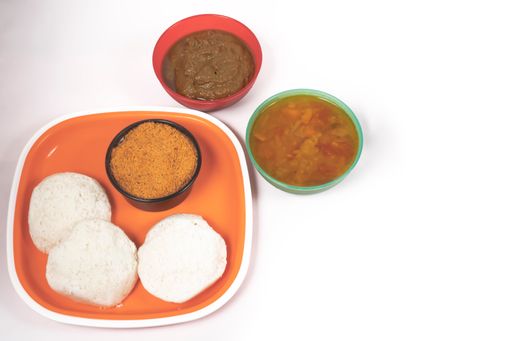 A closeup shot of Indian Idli food on an orange plate